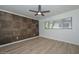 Bedroom with stylish accent wall, modern ceiling fan, and ample natural light at 3637 E Monterosa St # 8, Phoenix, AZ 85018