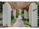 Charming entrance with a pergola, lush plants, and a secure gate at 3637 at 3637 E Monterosa St # 8, Phoenix, AZ 85018