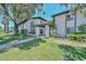 Inviting townhome with a lush green lawn, mature trees, and a charming pergola-covered entrance at 3637 E Monterosa St # 8, Phoenix, AZ 85018