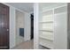 Hallway view to bathroom and closet with open shelves at 3637 E Monterosa St # 8, Phoenix, AZ 85018