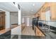Bright kitchen features stainless steel appliances, wood cabinets, and black countertops at 3637 E Monterosa St # 8, Phoenix, AZ 85018