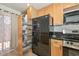 Kitchen features a laundry closet, stainless steel appliances, and wood cabinets at 3637 E Monterosa St # 8, Phoenix, AZ 85018