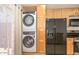 This condo features a stacked washer and dryer next to the refrigerator at 3637 E Monterosa St # 8, Phoenix, AZ 85018