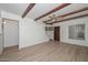 Comfortable living room featuring tile floors, rustic ceiling beams, and natural light at 3637 E Monterosa St # 8, Phoenix, AZ 85018