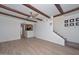 Open living room with tiled floors, stairs to the upper level, and kitchen pass-through at 3637 E Monterosa St # 8, Phoenix, AZ 85018
