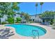 Sparkling community pool with lounge seating and palm trees in a well-maintained community at 3637 E Monterosa St # 8, Phoenix, AZ 85018