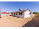 View of the rear of the home showing minimal landscaping and perimeter fence at 3812 W Seldon Ln, Phoenix, AZ 85051