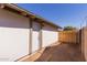 View of the exterior of the house and backyard featuring a wooden fence at 3812 W Seldon Ln, Phoenix, AZ 85051