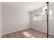 Bright bedroom featuring wood-look flooring and brick accent wall at 3812 W Seldon Ln, Phoenix, AZ 85051