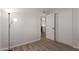 Neutral bedroom featuring hardwood floors, an open closet, and overhead lighting at 3812 W Seldon Ln, Phoenix, AZ 85051