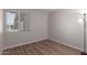 Bright bedroom featuring hardwood floors, large window, and neutral paint at 3812 W Seldon Ln, Phoenix, AZ 85051