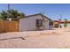 Side exterior view, displaying desert landscaping, privacy fence, and well-kept facade at 3812 W Seldon Ln, Phoenix, AZ 85051