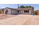 Front house view with desert landscaping, garage, and spacious driveway at 3812 W Seldon Ln, Phoenix, AZ 85051