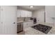 Modern kitchen featuring stainless steel appliances, granite countertops, and white cabinetry at 3812 W Seldon Ln, Phoenix, AZ 85051