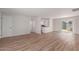 Spacious open-concept living area with modern floors, fresh paint, and a view of the kitchen and backyard at 3812 W Seldon Ln, Phoenix, AZ 85051