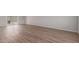 Bright, renovated living room featuring modern vinyl floors, a large sliding glass door, and neutral paint at 3812 W Seldon Ln, Phoenix, AZ 85051