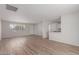 Bright living area with updated vinyl floors, neutral walls, and an open layout to the kitchen at 3812 W Seldon Ln, Phoenix, AZ 85051
