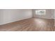 Well-lit room with vinyl flooring, brick wall, and a window overlooking the neighborhood at 3812 W Seldon Ln, Phoenix, AZ 85051