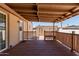 Covered wooden back porch features a built-in bench and faces a tidy gravel yard at 3952 E Baywood Ave, Mesa, AZ 85206