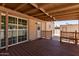 Covered back porch with bench seating and sliding glass door entry to the house at 3952 E Baywood Ave, Mesa, AZ 85206