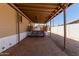 Backyard with covered deck, paver patio, gravel yard, and stairs leading to upper-level porch at 3952 E Baywood Ave, Mesa, AZ 85206