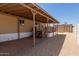 Gravel backyard with covered back porch, patio, and stairs leading to porch at 3952 E Baywood Ave, Mesa, AZ 85206