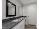 Remodeled bathroom featuring granite countertops, custom lighting and large mirrors at 3952 E Baywood Ave, Mesa, AZ 85206