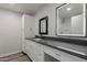 Bright bathroom featuring granite countertops, white cabinetry, and framed mirrors at 3952 E Baywood Ave, Mesa, AZ 85206