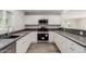Updated kitchen boasts stainless appliances, grey counter tops and ample storage space at 3952 E Baywood Ave, Mesa, AZ 85206