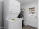 Laundry room featuring a stacked washer/dryer and water heater at 3952 E Baywood Ave, Mesa, AZ 85206