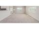 Bright living room featuring plush carpeting, large windows, and an open floor plan at 3952 E Baywood Ave, Mesa, AZ 85206