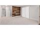 Open living room featuring a wood accent wall, plush carpeting, and neutral paint tones at 3952 E Baywood Ave, Mesa, AZ 85206