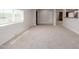 Spacious living room featuring plush carpeting, recessed lighting, and neutral paint tones at 3952 E Baywood Ave, Mesa, AZ 85206