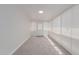 Bright sunroom features neutral carpet, white walls and trim, and plenty of windows at 3952 E Baywood Ave, Mesa, AZ 85206