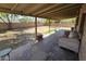 Covered patio with outdoor seating area, potted plants, and views of the backyard at 4112 S Grandview Ave, Tempe, AZ 85282