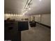 Unfinished basement featuring track lighting, concrete floor, and cinder block walls at 4112 S Grandview Ave, Tempe, AZ 85282