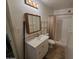Bathroom featuring a vanity with a sink, mirrored cabinet, toilet, and shower stall at 4112 S Grandview Ave, Tempe, AZ 85282