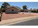 Exterior view of brick home with manicured desert landscape, a paved driveway, and mature trees at 4112 S Grandview Ave, Tempe, AZ 85282