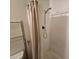 Bright bathroom shower featuring adjustable shower head and simple shower curtain at 4112 S Grandview Ave, Tempe, AZ 85282