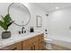 Bathroom with a plant, modern fixtures and a shower/tub combo at 4842 E Surrey Ave, Scottsdale, AZ 85254