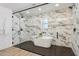 Luxury bathroom featuring a freestanding tub, marble tile and a glass shower at 4842 E Surrey Ave, Scottsdale, AZ 85254