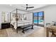 Bright bedroom features a four poster bed and sliding glass doors out to the pool at 4842 E Surrey Ave, Scottsdale, AZ 85254