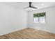 Spacious empty bedroom with a ceiling fan and a large window at 4842 E Surrey Ave, Scottsdale, AZ 85254