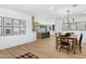Open-concept dining room featuring wood flooring, black and white accents, and contemporary light fixtures at 4842 E Surrey Ave, Scottsdale, AZ 85254