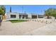 Charming home featuring desert landscaping, decorative stone walkway, and a two-car garage at 4842 E Surrey Ave, Scottsdale, AZ 85254