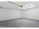 Clean garage featuring a custom-designed epoxy floor and modern hexagonal lighting at 4842 E Surrey Ave, Scottsdale, AZ 85254