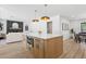 Gourmet kitchen island with modern appliances, natural wood cabinets, and open concept to living areas at 4842 E Surrey Ave, Scottsdale, AZ 85254