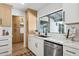 Bright kitchen featuring white subway tile backsplash, light wood cabinets, stainless steel appliances, and quartz countertops at 4842 E Surrey Ave, Scottsdale, AZ 85254