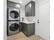 Laundry room with a stackable washer and dryer and storage space at 4842 E Surrey Ave, Scottsdale, AZ 85254