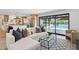 Bright, modern living room with sectional sofa and view of the backyard pool at 4842 E Surrey Ave, Scottsdale, AZ 85254